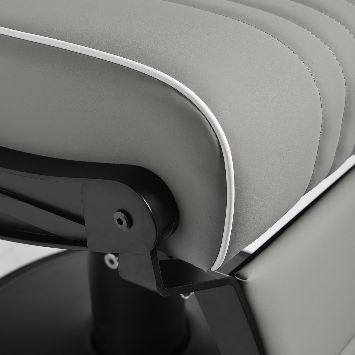 Gabbiano Levi barber chair in grey with black frame, featuring padded seat and backrest, for professional barbershop use.
