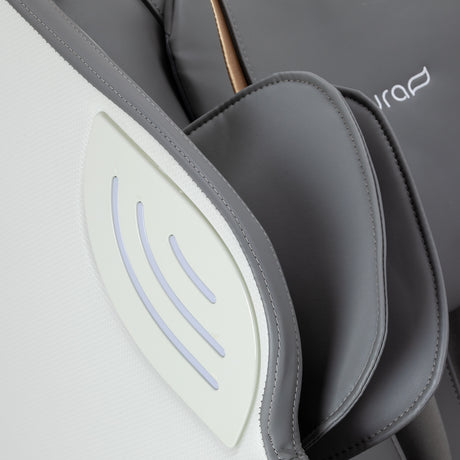 White and grey Sakura 3D Maximus massage chair with ergonomic design and padded armrests, showcasing its modern massage furniture features.