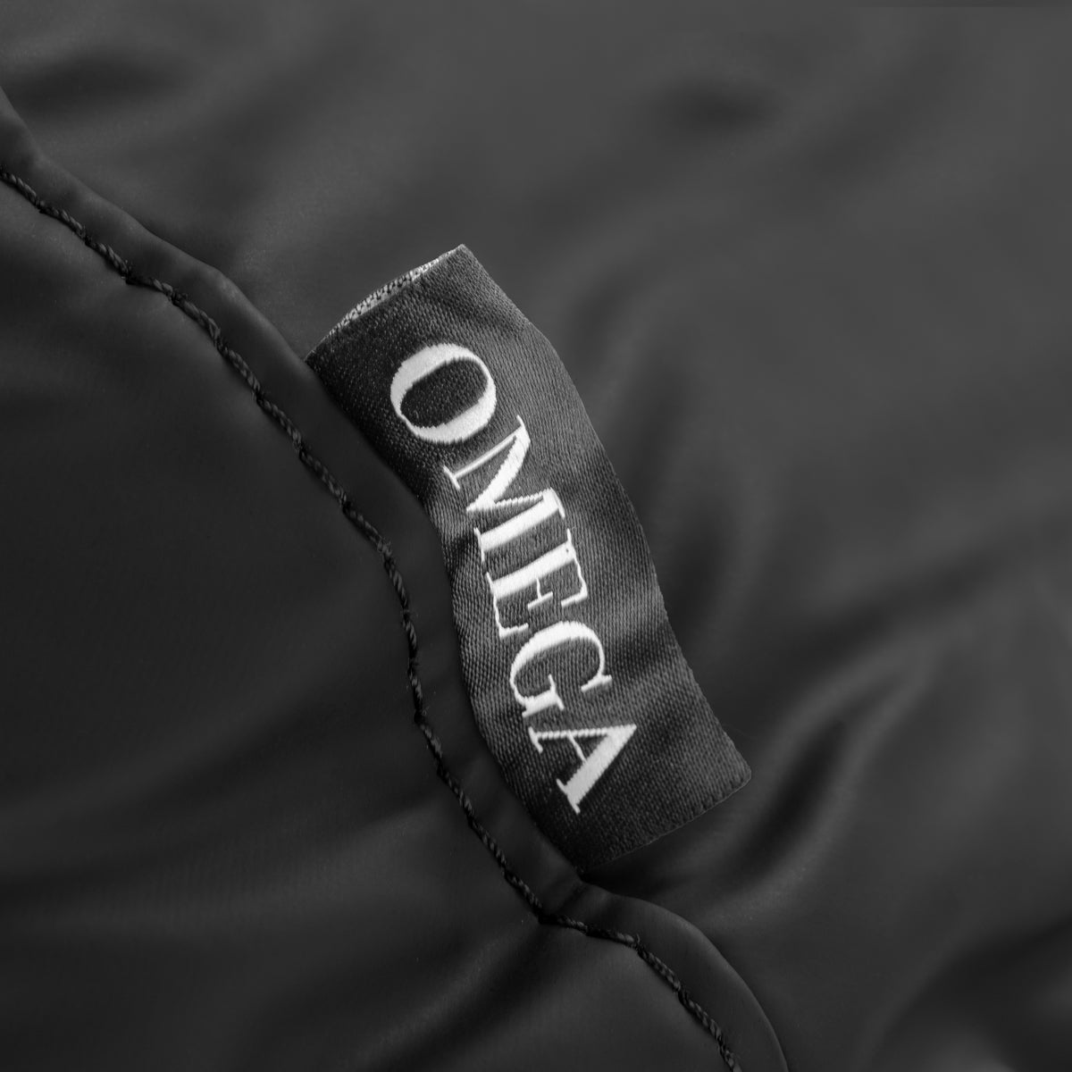 Omega black headrest for hairdressing wash unit, adjustable cushion support for comfortable hair washing.