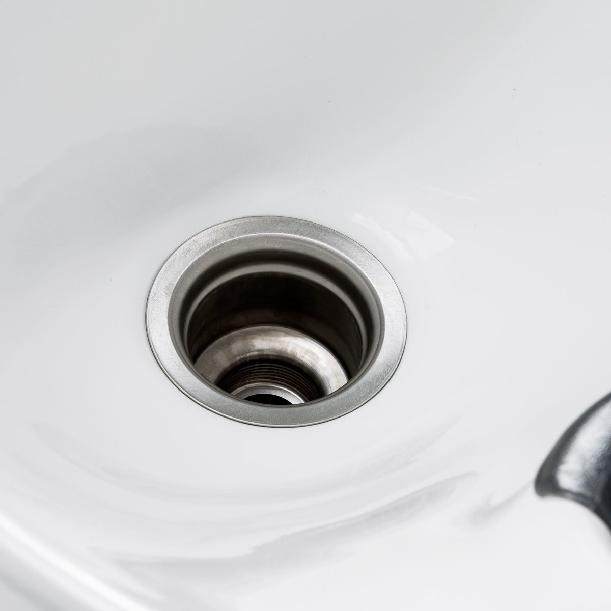 White salon wash station with ceramic basin and comfortable backrest