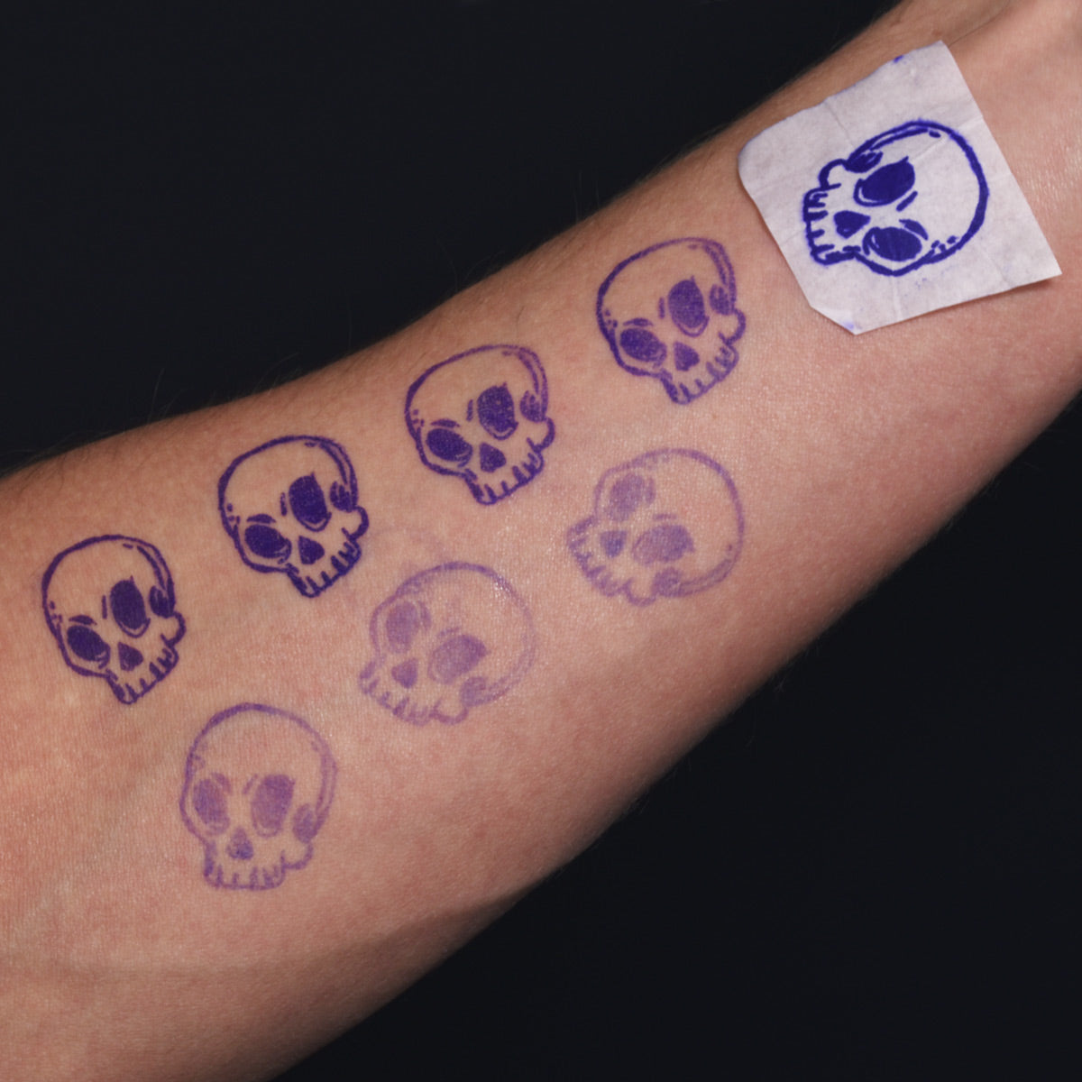 Pack of 25 Sirius universal tattoo stencil transfer papers with black hectographic ink for precise tattoo design transfer.